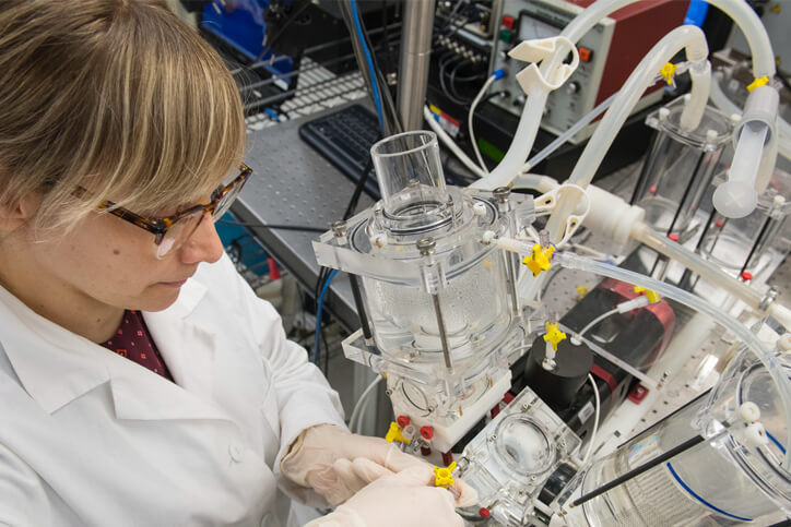 A scientist working in a lab with equipment.