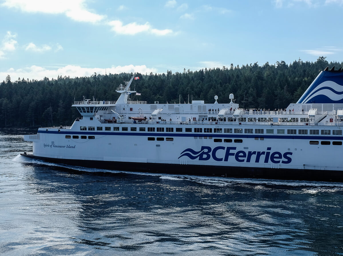 The BC Ferries vessel "Spirit of Vancouver Island" seen with trees in the immediate background.