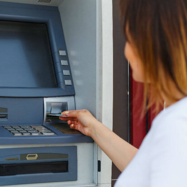 woman inserting card in ATM