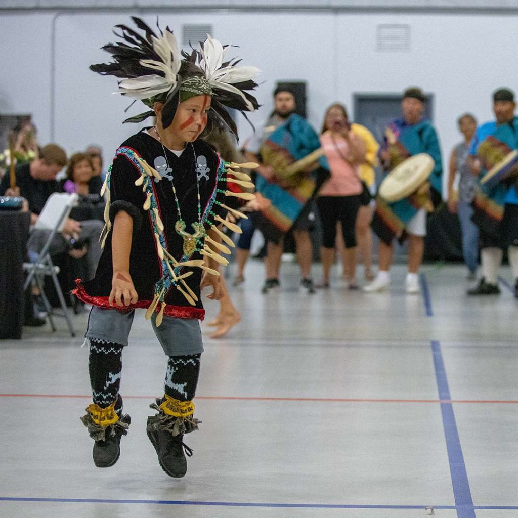 Indigenous boy dancing at event