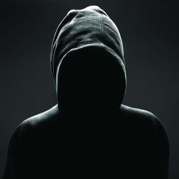 hooded person in the dark