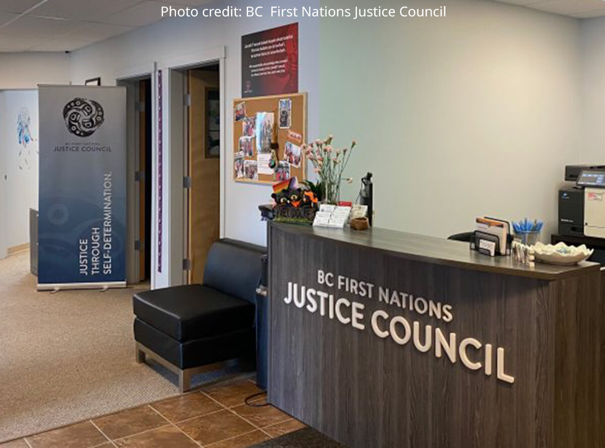 The front desk of the BC First Nations Justice Council. A banner reads "Justice Through Self-Determination".