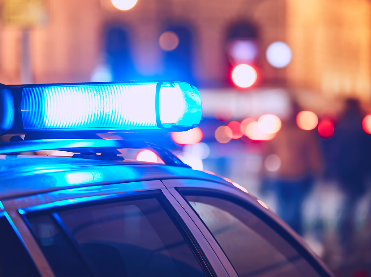 Close-up shot of a police car's flashing blue light.